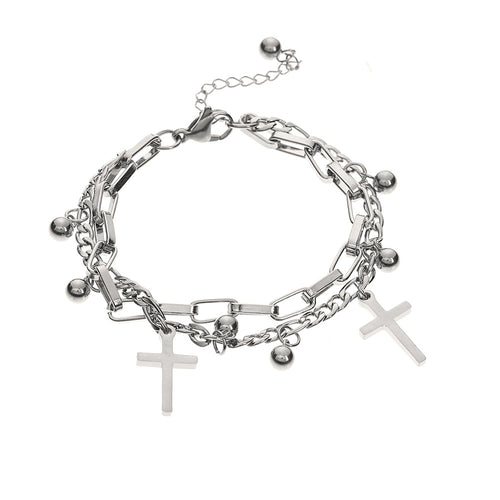 Silver chain bracelet with cross charms on a white background