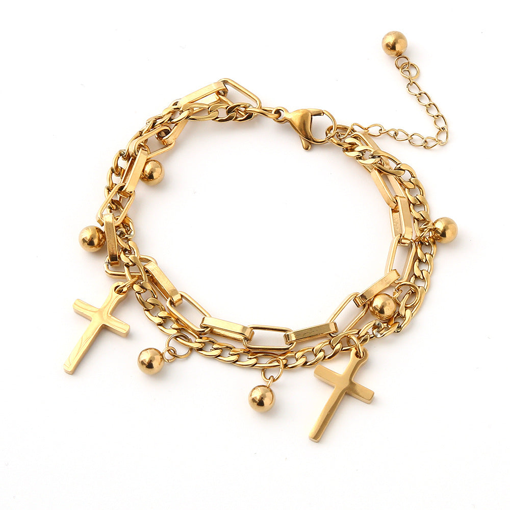 Gold bracelet with various charms on a white background