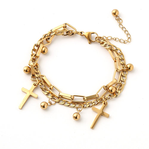Gold bracelet with various charms on a white background