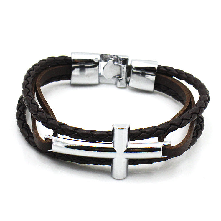 Black braided leather bracelet with silver cross charm and clasp on a white background