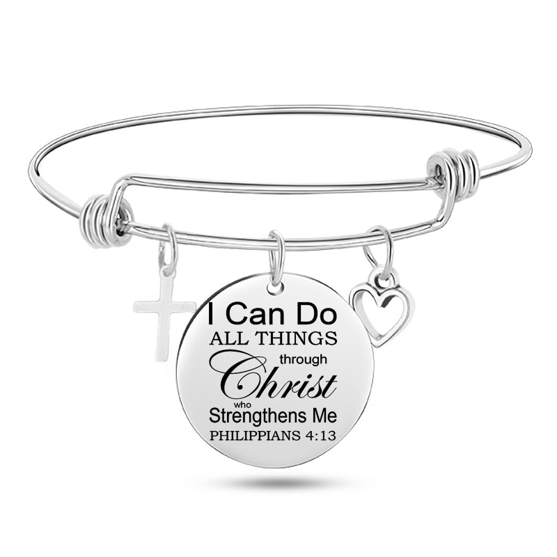 Silver bracelet with circular charm featuringPhilippians 4:13 on a white background