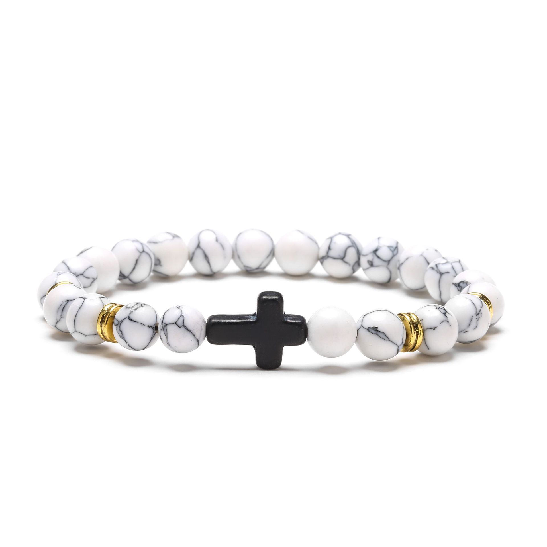 Bracelet with white marbled beads and black and gold cross charm on a white background