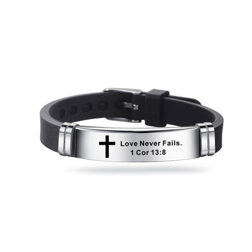 Black leather bracelet with silver tag featuring a cross and engraved text on a white background