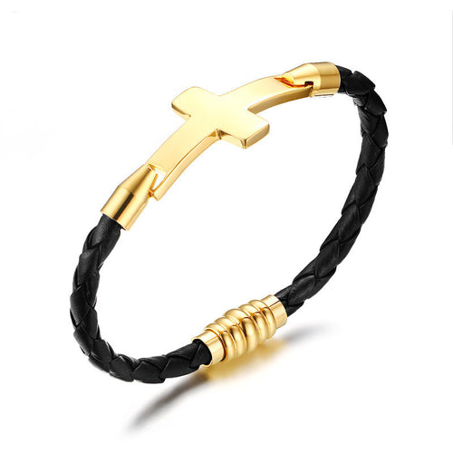 Black braided leather bracelet with gold cross and cylindrical beads on a white background