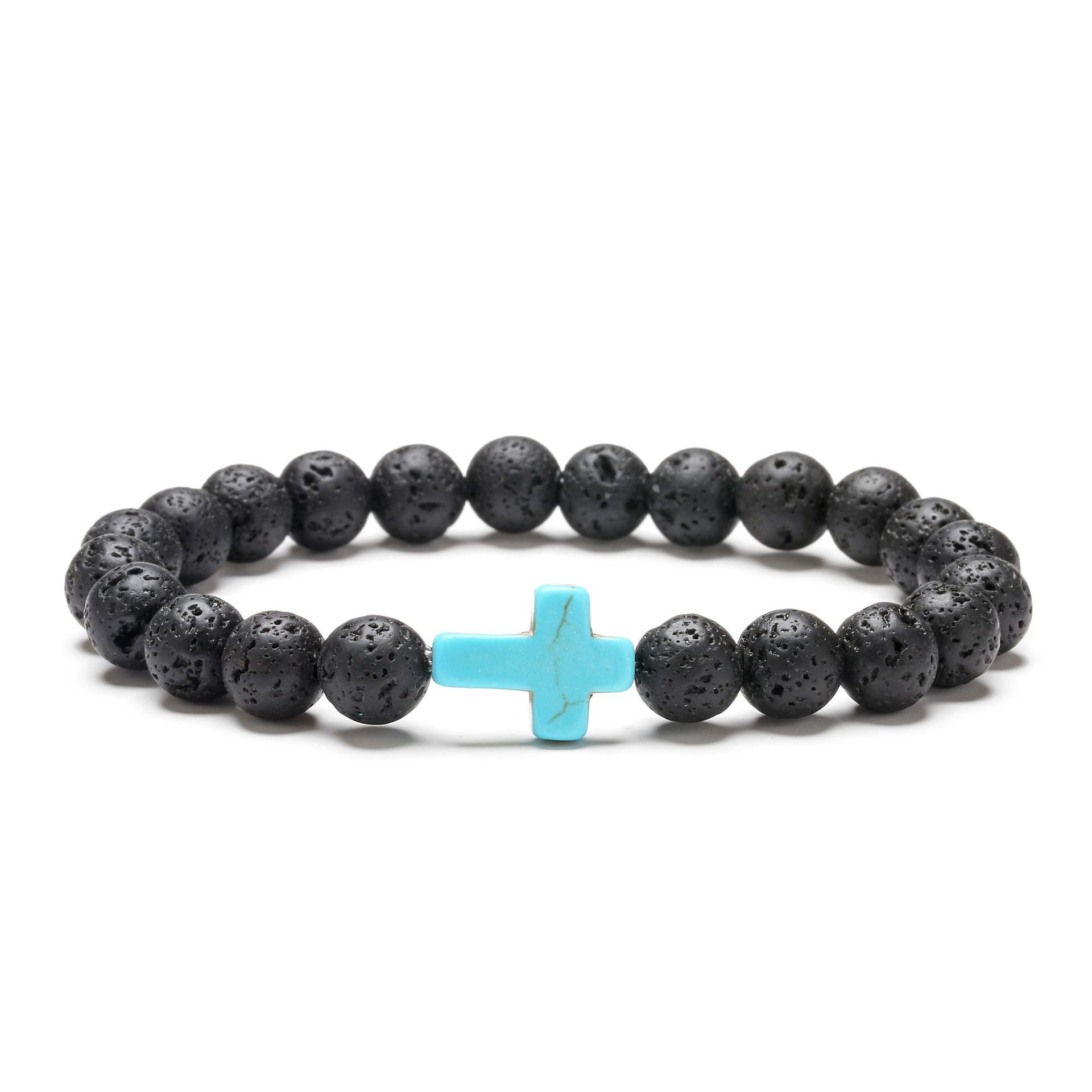 Black beaded bracelet with a turquoise cross on a white background