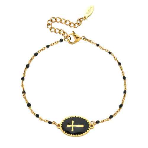 Gold bracelet with black beads and a central black disc featuring a gold cross on a white background.