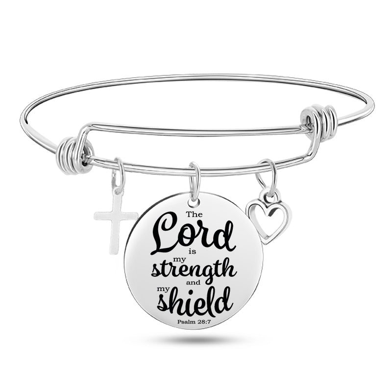 Silver bracelet with a round charm featuring 'The Lord is my strength and my shield' text on a white background.