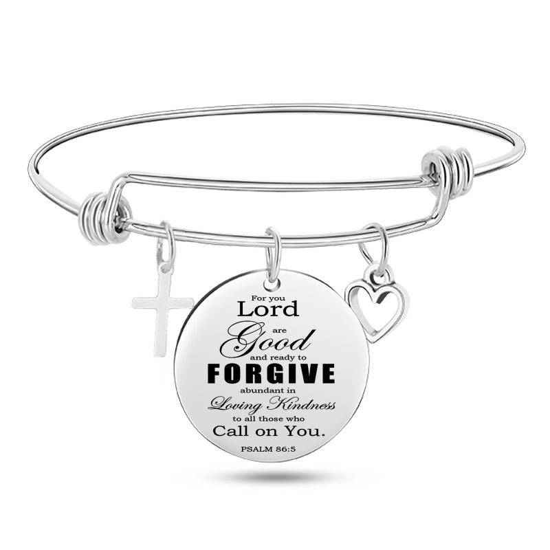 Silver bracelet with a round engraved disc on a white background