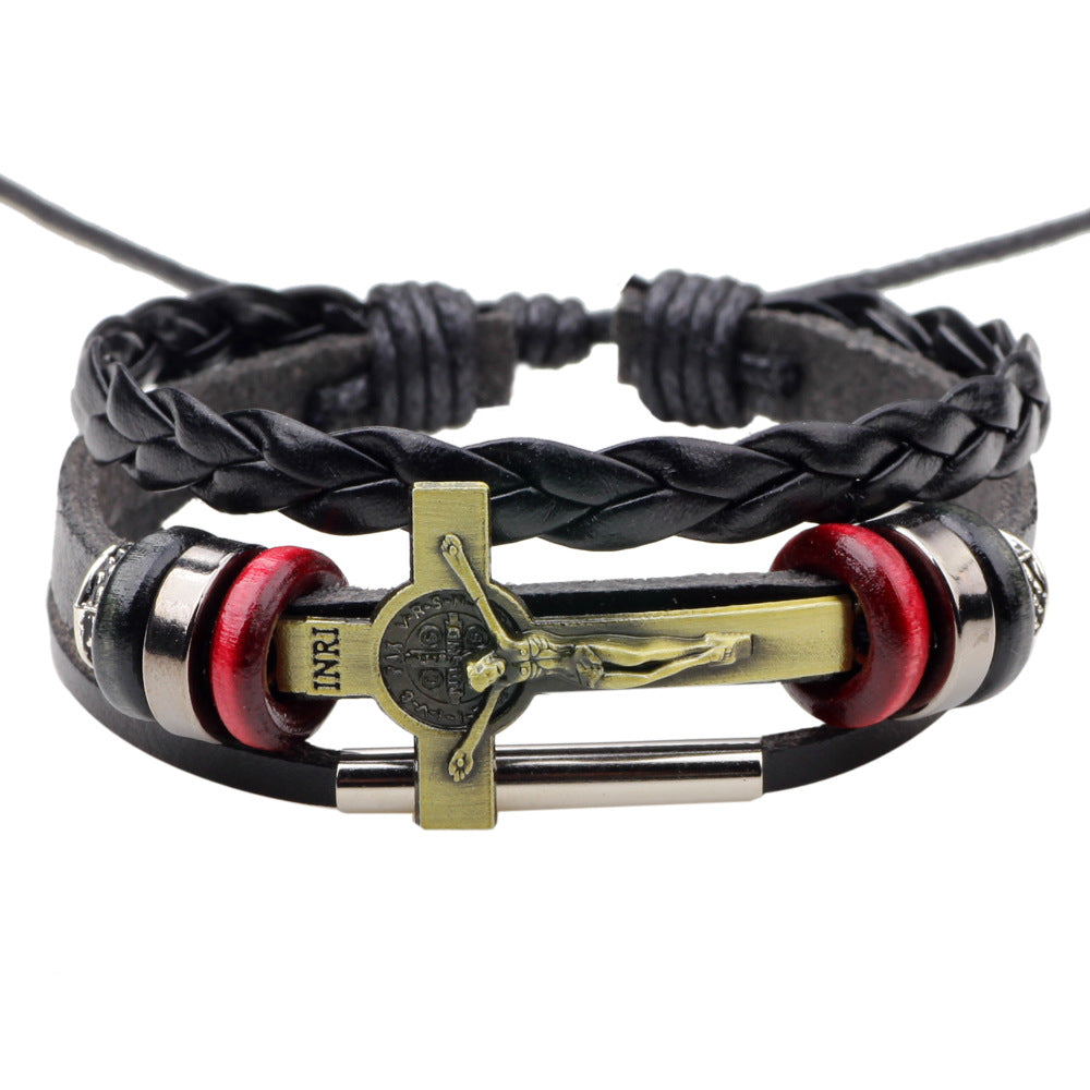 Black braided leather bracelet with a gold cross charm on a white background