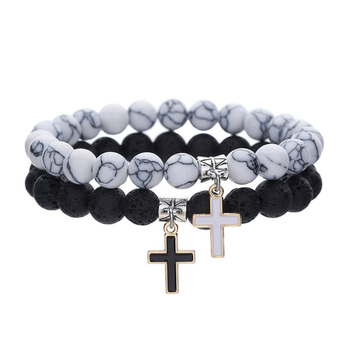 Set of two beaded bracelets with cross charms on a white background